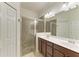 This bathroom features a double vanity, a shower with glass doors, and plenty of storage at 24068 Canterwood Way, Venice, FL 34293