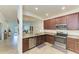 Well-equipped kitchen with stainless steel appliances, granite countertops, and ample cabinet space at 24068 Canterwood Way, Venice, FL 34293
