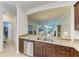 Open kitchen view with granite countertops, a stainless steel sink, and a view into the dining and living areas at 24068 Canterwood Way, Venice, FL 34293