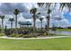 Community playground by the lake offers a fun space for with secure fencing and green surroundings at 24068 Canterwood Way, Venice, FL 34293