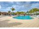 Beautiful swimming pool with comfortable lounge chairs and palm trees at 24068 Canterwood Way, Venice, FL 34293