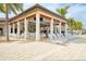 Poolside dining area with ample seating, bar, and shaded lounging at 24068 Canterwood Way, Venice, FL 34293
