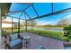 Screened lanai with brick flooring, comfortable seating and a beautiful view of the lake at 24068 Canterwood Way, Venice, FL 34293