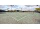 Well-maintained tennis court with a new net, benches, and lighting for evening play at 24068 Canterwood Way, Venice, FL 34293