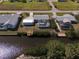 Aerial view showcasing a home with a pool, screened lanai, and a private dock on the canal at 2502 Larkspur Dr, Punta Gorda, FL 33950
