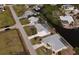 Aerial view of waterfront homes with canals, pools, and well-manicured lawns in a desirable neighborhood at 2502 Larkspur Dr, Punta Gorda, FL 33950