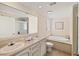 Bright bathroom with double sinks, soaking tub, and separate shower at 2502 Larkspur Dr, Punta Gorda, FL 33950