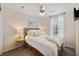 Comfortable bedroom with a queen-sized bed, ceiling fan, and view of the exterior at 2502 Larkspur Dr, Punta Gorda, FL 33950