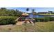 Inviting waterfront dock with tiki hut, perfect for relaxing by the canal and enjoying scenic views at 2502 Larkspur Dr, Punta Gorda, FL 33950