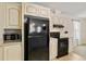 This kitchen is equipped with black appliances and cream-colored cabinets for a modern touch at 2502 Larkspur Dr, Punta Gorda, FL 33950