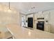 Well-lit kitchen with a breakfast bar, black appliances, and neutral countertops for a modern touch at 2502 Larkspur Dr, Punta Gorda, FL 33950