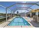 Screened in pool with patio furniture, waterfront views, and clear blue water at 2502 Larkspur Dr, Punta Gorda, FL 33950