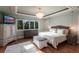 Bright bedroom featuring hardwood floors, a decorative chandelier, and large windows at 288 Island Cir, Sarasota, FL 34242