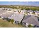 Aerial view of a house with a screened in lanai and lush landscaping in a residential neighborhood at 2962 Trustee Ave, Sarasota, FL 34243