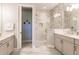 Bathroom showcasing dual vanities, a glass-enclosed shower with tiled walls, and stylish fixtures at 2962 Trustee Ave, Sarasota, FL 34243