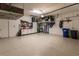 Spacious two car garage with epoxy floor, storage cabinets, ceiling storage, and tool storage at 2962 Trustee Ave, Sarasota, FL 34243