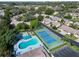Aerial view showcasing a pool, shuffleboard courts, tennis court, and well-maintained community landscaping at 315 30Th W Ave # B214, Bradenton, FL 34205