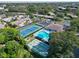 Aerial view of community featuring a pool, shuffleboard courts, tennis court, and lush landscaping at 315 30Th W Ave # B214, Bradenton, FL 34205