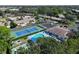 Aerial view showcases community amenities including a pool, tennis court, and lush landscaping at 315 30Th W Ave # B214, Bradenton, FL 34205