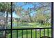 Serene view from the balcony overlooking a lush backyard and a tranquil pond at 315 30Th W Ave # B214, Bradenton, FL 34205