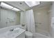 Bright bathroom with a combination shower and tub with white tile at 315 30Th W Ave # B214, Bradenton, FL 34205