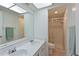Bright bathroom features double sinks, a glass-enclosed shower, and neutral tile at 315 30Th W Ave # B214, Bradenton, FL 34205