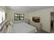 Comfortable bedroom features a bed, fan, natural light, dresser, and wall-mounted tv at 315 30Th W Ave # B214, Bradenton, FL 34205