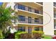 Well-maintained exterior of a building with manicured landscaping and mature palm trees at 315 30Th W Ave # B214, Bradenton, FL 34205