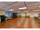 Spacious common room with hardwood floors, comfortable seating, and large windows, creating a welcoming social gathering space at 315 30Th W Ave # B214, Bradenton, FL 34205