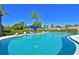 Beautiful community pool with clear blue water, lounge chairs, and shade, perfect for relaxing and enjoying the outdoors at 315 30Th W Ave # B214, Bradenton, FL 34205