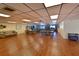 Large community room with hardwood floors, flexible seating arrangements, and ample space for group activities and social events at 315 30Th W Ave # B214, Bradenton, FL 34205