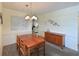 Comfortable dining area with wooden table and chairs, adjacent to living room at 315 30Th W Ave # B214, Bradenton, FL 34205