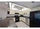 Efficient kitchen with modern black appliances, ample counter space, and tiled flooring at 315 30Th W Ave # B214, Bradenton, FL 34205
