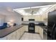Bright kitchen with modern appliances, neutral cabinets, and a well-lit ceiling fixture at 315 30Th W Ave # B214, Bradenton, FL 34205