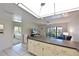 Bright living room with balcony access, featuring a full view of the kitchen and a peek of the bedroom at 315 30Th W Ave # B214, Bradenton, FL 34205