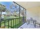 Relaxing screened balcony with a peaceful view of the lush landscaping and pond at 315 30Th W Ave # B214, Bradenton, FL 34205