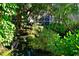 Lush landscaping surrounding a pond with a mossy rock water feature, offering a serene and natural environment at 315 30Th W Ave # B214, Bradenton, FL 34205