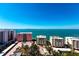 Expansive aerial view capturing the serene blue waters, nearby buildings, and lush landscapes at 35 Watergate Dr # 1103, Sarasota, FL 34236