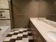 Bathroom featuring a dual sink vanity, large mirror and a step-in shower at 35 Watergate Dr # 1103, Sarasota, FL 34236