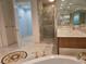 Modern bathroom with glass shower, granite countertops, dual sinks, and travertine flooring at 35 Watergate Dr # 1103, Sarasota, FL 34236
