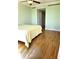 Bright bedroom features hardwood floors, neutral paint, and access to the ensuite bathroom at 35 Watergate Dr # 1103, Sarasota, FL 34236