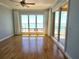 Bedroom featuring hardwood floors, ceiling fan, floor to ceiling windows with panoramic water views at 35 Watergate Dr # 1103, Sarasota, FL 34236