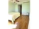 Bright bedroom with hardwood floors, ceiling fan, and ensuite bathroom entry at 35 Watergate Dr # 1103, Sarasota, FL 34236