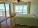 Light-filled bedroom featuring a large window and sliding glass door with beautiful water views at 35 Watergate Dr # 1103, Sarasota, FL 34236