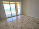 Bright room with tile floor with decorative black squares and a view of the water at 35 Watergate Dr # 1103, Sarasota, FL 34236