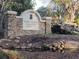 Community entrance stone sign with waterfall feature and manicured landscaping at 35 Watergate Dr # 1103, Sarasota, FL 34236