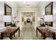 Elegant hallway featuring a chandelier, patterned carpet, and mirrored accents for a luxurious feel at 35 Watergate Dr # 1103, Sarasota, FL 34236