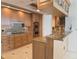 Modern kitchen featuring granite countertops, custom cabinets, stainless steel appliances, and an island bar at 35 Watergate Dr # 1103, Sarasota, FL 34236