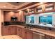 Gourmet kitchen featuring custom cabinetry, granite counters, and stainless appliances, with views of the water at 35 Watergate Dr # 1103, Sarasota, FL 34236
