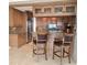 Beautiful kitchen featuring custom cabinets, granite countertops, stainless appliances, and bar stool seating at 35 Watergate Dr # 1103, Sarasota, FL 34236